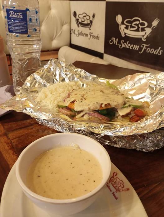 Foil-wrapped sandwich with coffee