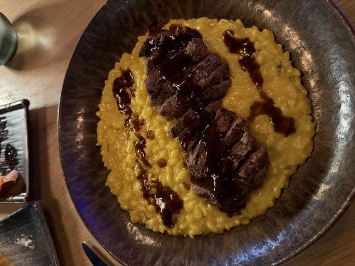 Steak over saffron risotto